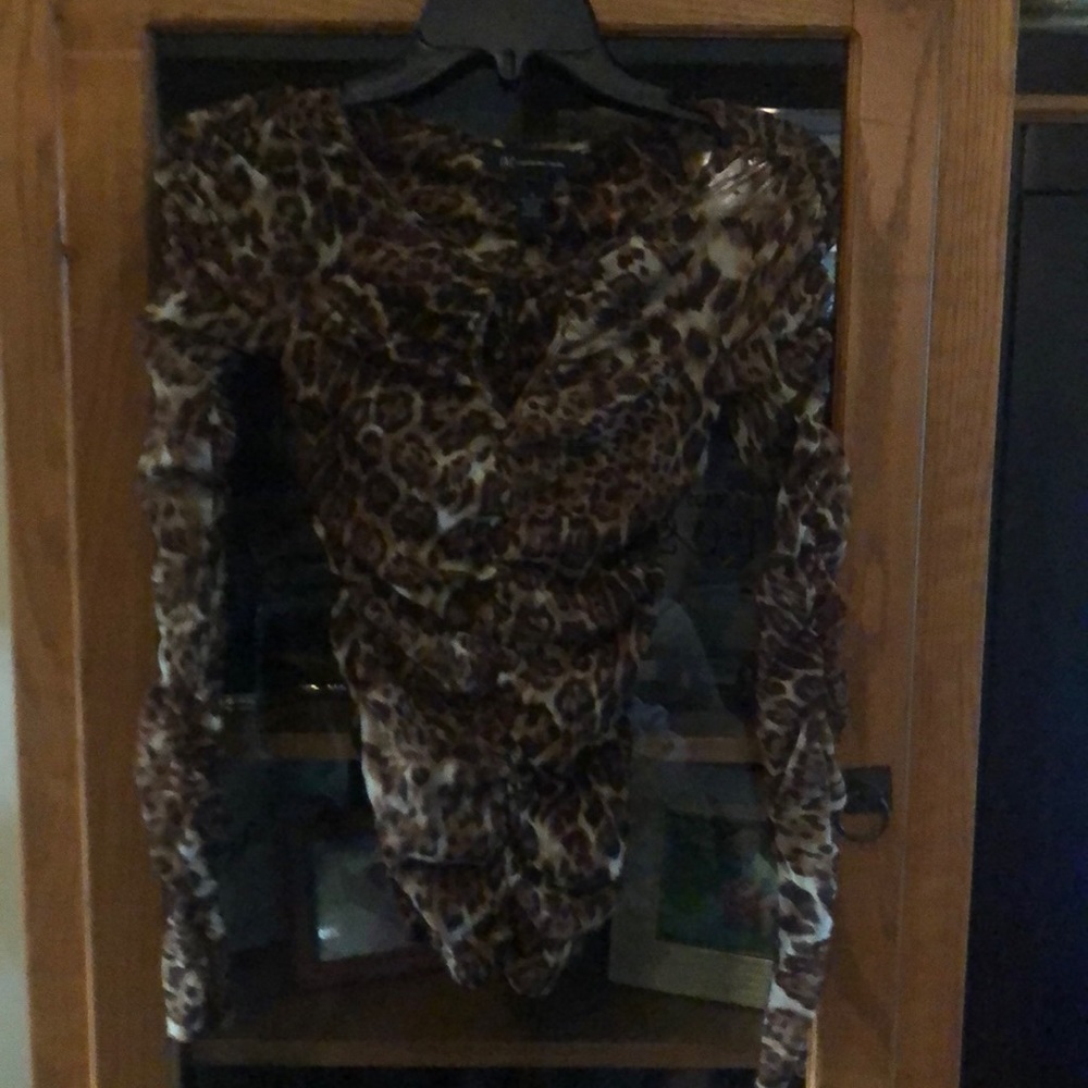 INC Leopard print top. Peak-a-boo neckline.